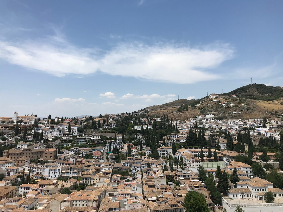 View over Granada's old town rooftops from the Alhambra, with the Albaicín quarter and hills beyond