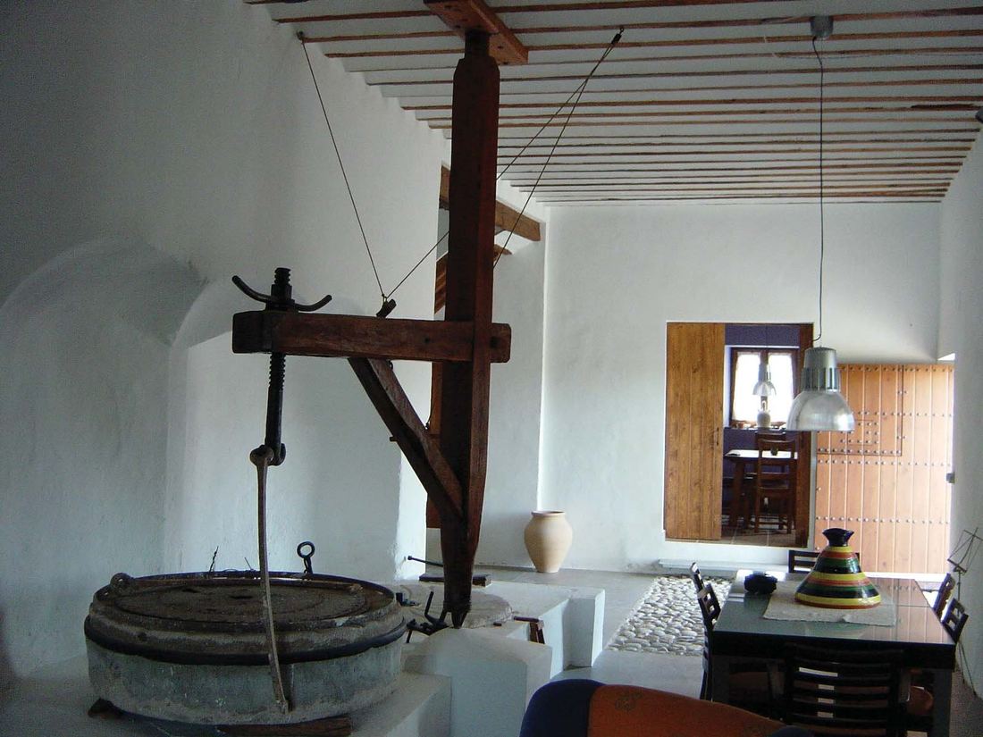 The old grinding mechanism, preserved inside the ground-floor living room of Molino de Guevara